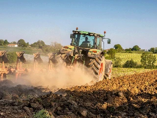 Tracteur labourant la terre dans les champs.