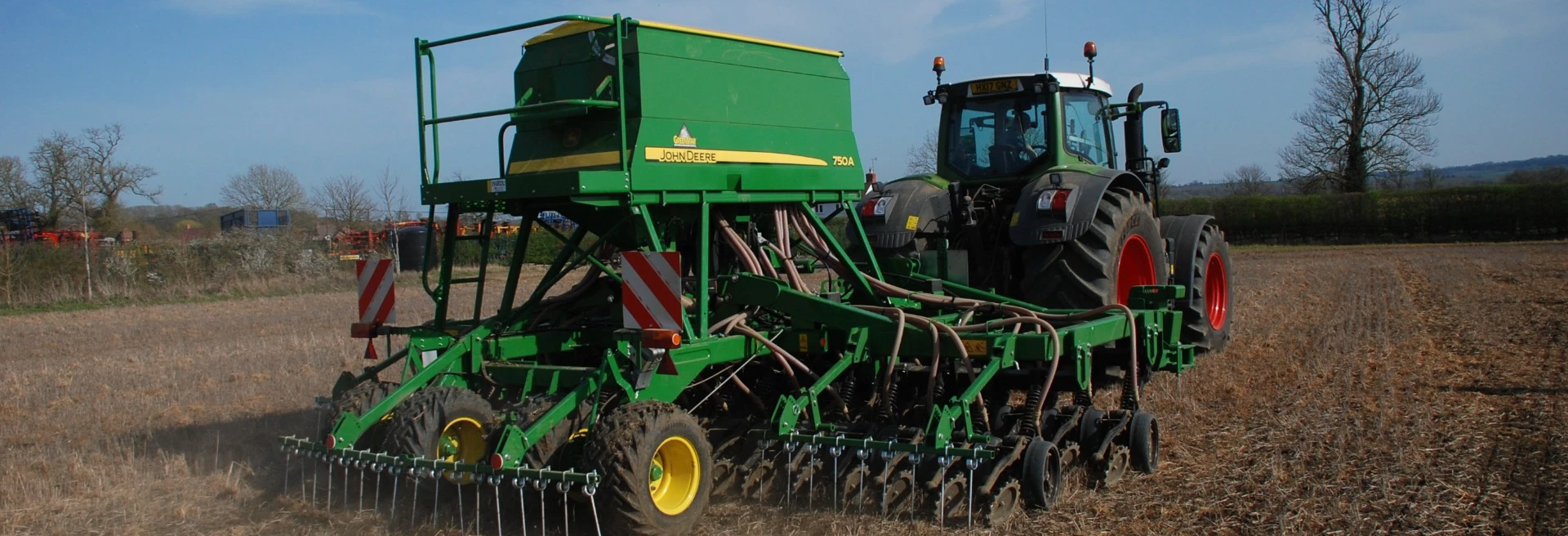 A john Deer 750A direct drill, drilling seeds directly into an uncultivated plot on AMTEC's own farm
